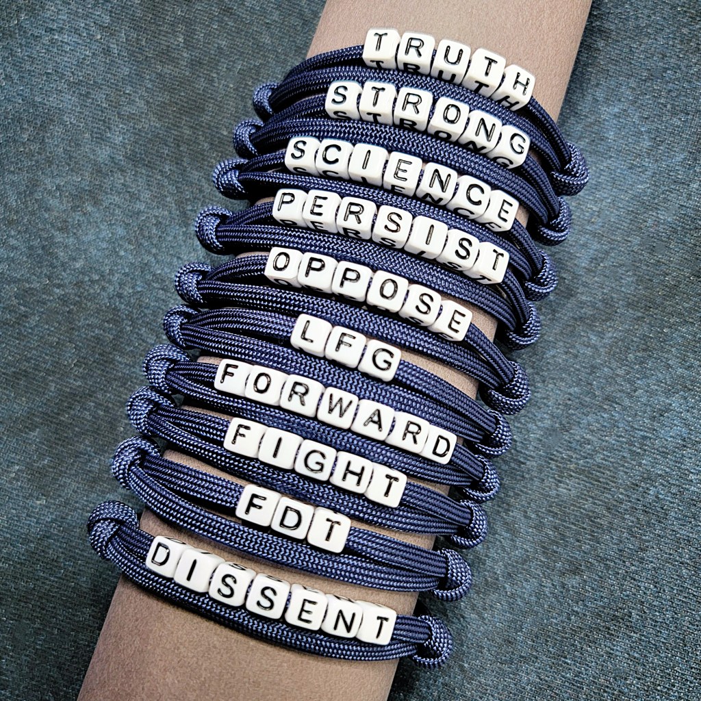 A collection of letter bead bracelets spelling out the words Truth, Strong, Science, Persist, Oppose, LFG, Forward, Fight, FDT and Dissent.